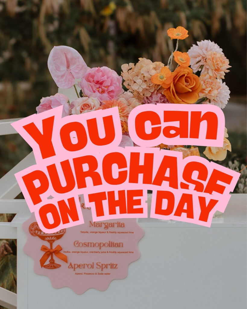 Colorful bouquet of pink, peach, and orange flowers with a bold pink sign reading 'You Can Purchase On The Day' over the arrangement.