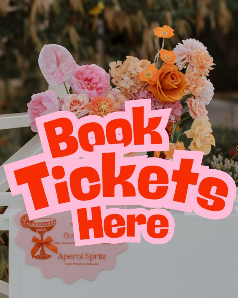 Colorful bouquet of pink and orange flowers with a pink 'Book Tickets Here' graphic overlay partially obscuring the flowers.