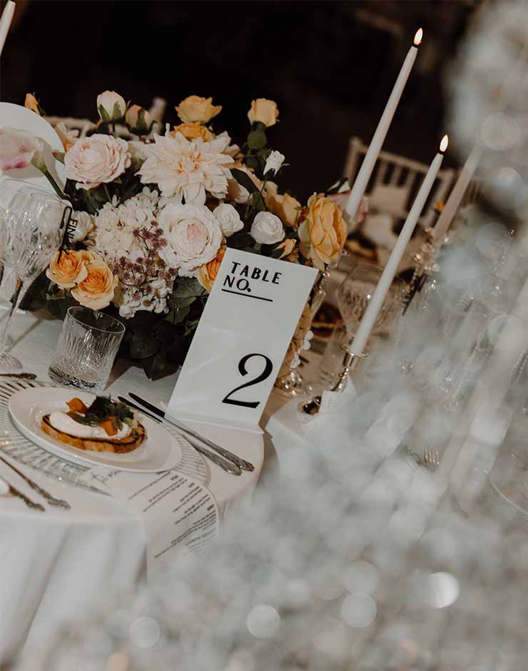 4 - I do I do Gippsland Elegant table setting with pale pink and peach flowers, tall candles, and a table number card reading Table No. 2.